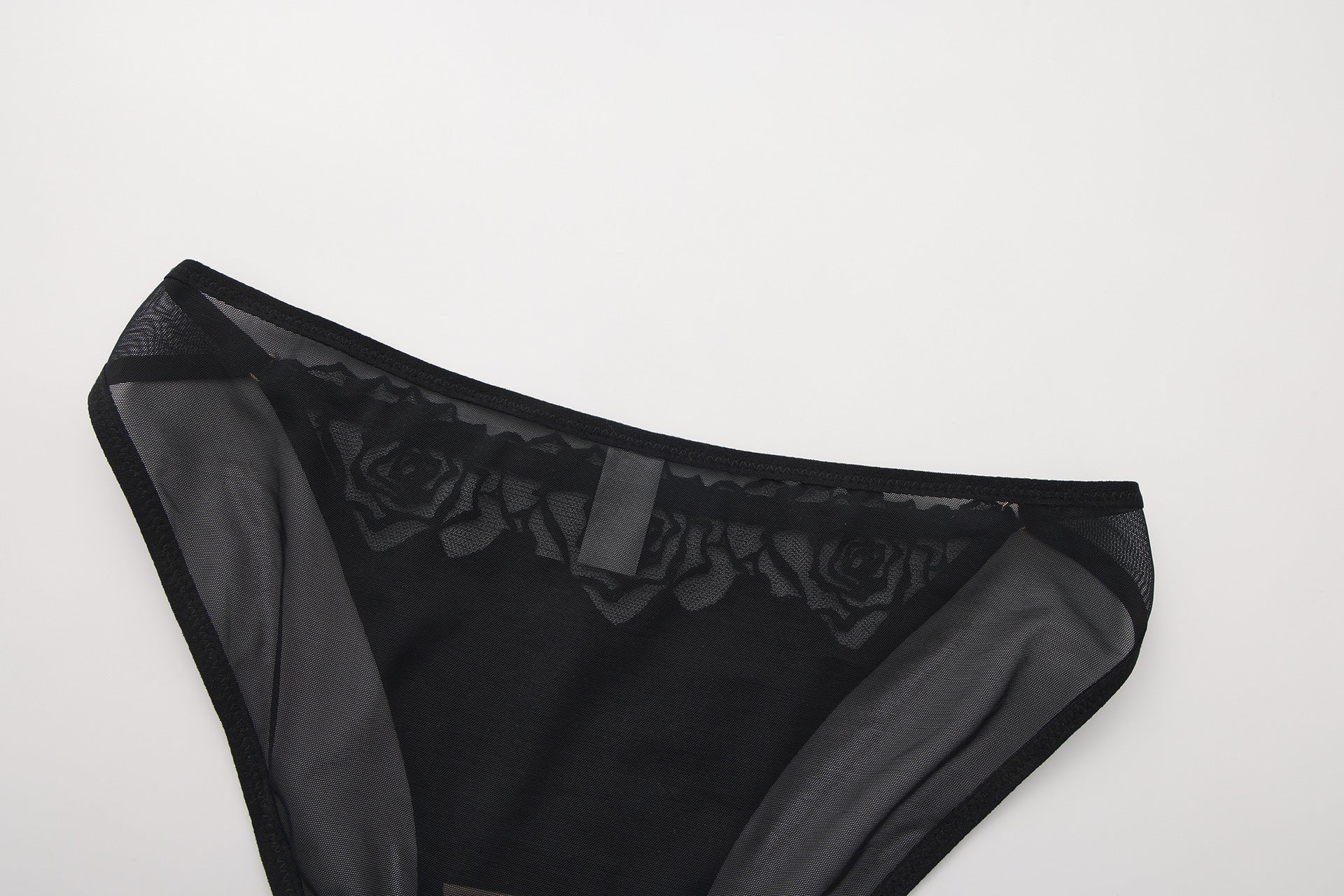 Rear view of the Aeris Noir mesh brief showing the sheer back coverage and seamless elastic edges.