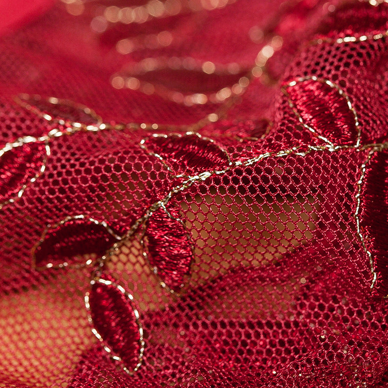 Close-up of floral embroidery on sheer mesh fabric.