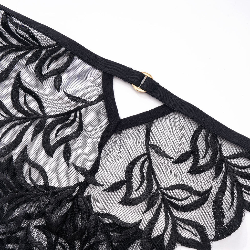 Macro shot of the "line art" botanical embroidery on high-clarity sheer mesh, back view.