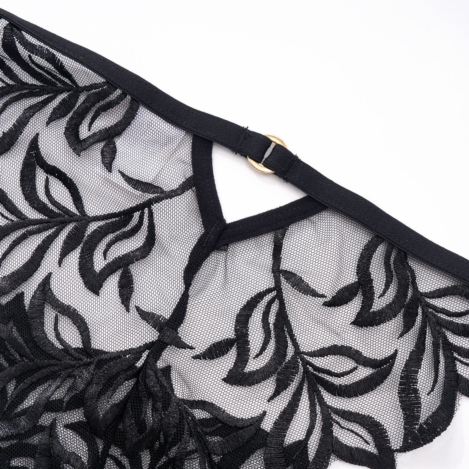 Macro shot of the "line art" botanical embroidery on high-clarity sheer mesh, back view.