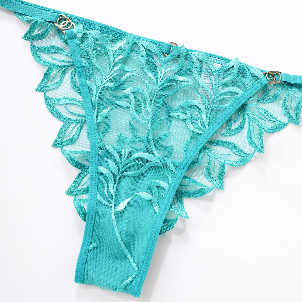Front view of the Emerald green botanical embroidered brief with sheer mesh, lying.