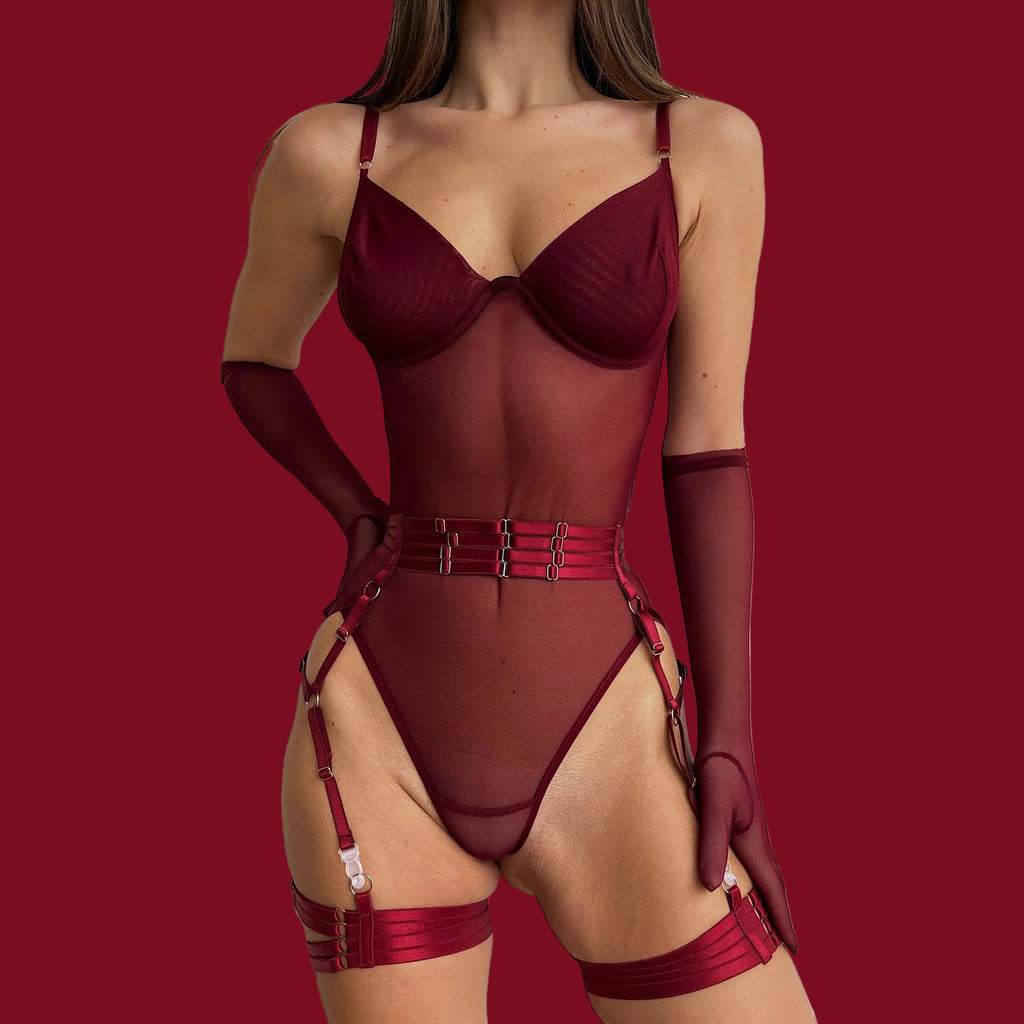 A front-view editorial shot of the burgundy mesh bodysuit, featuring matching sheer gloves and buckled harness details against a deep red background.