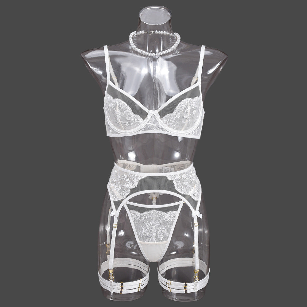 Front view on a transparent mannequin, showcasing the "floating" floral effect of the sheer white 3-piece set.
