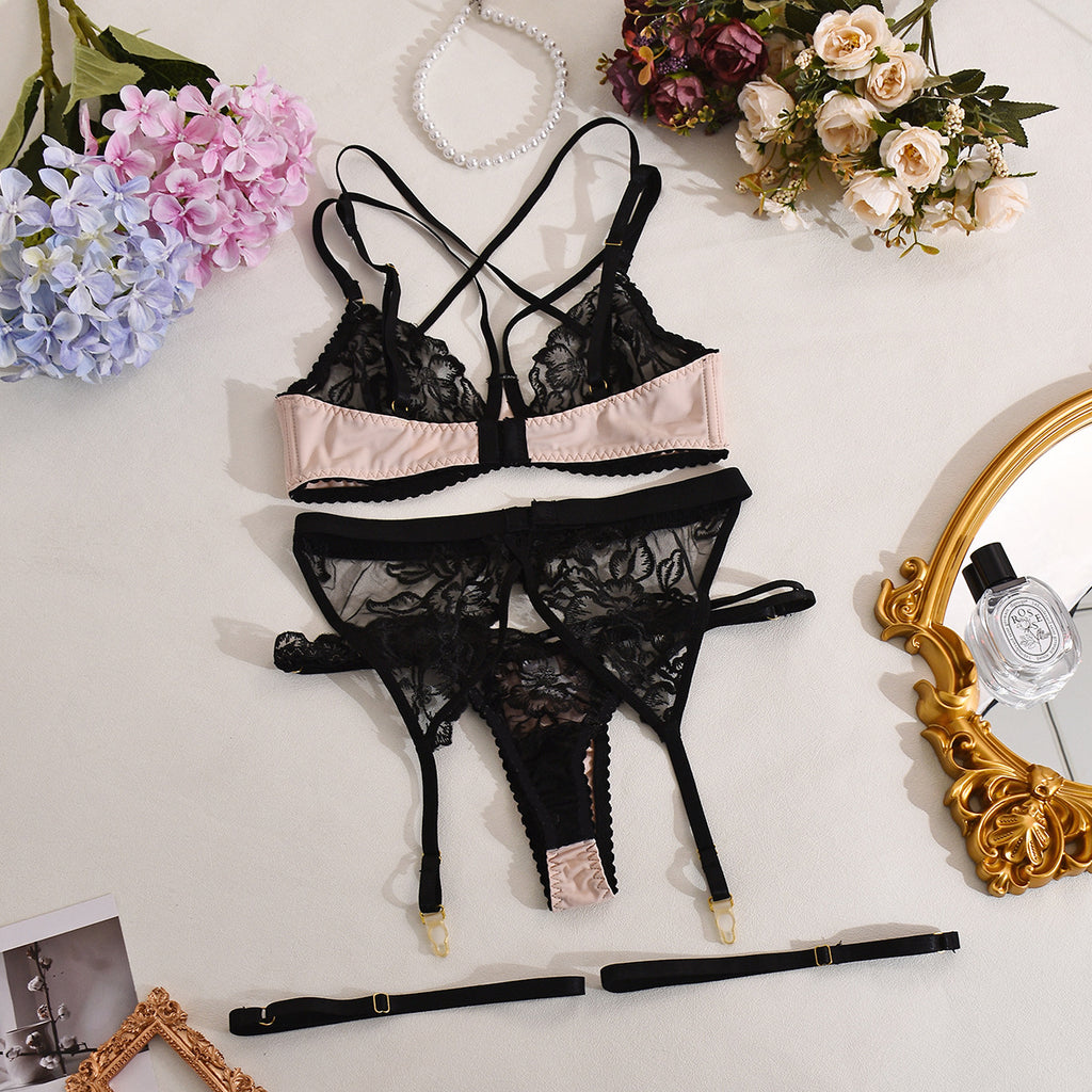 A complete back view of the Fleur Obscura archive, demonstrating the symmetry of the garter straps and adjustable satin closures.