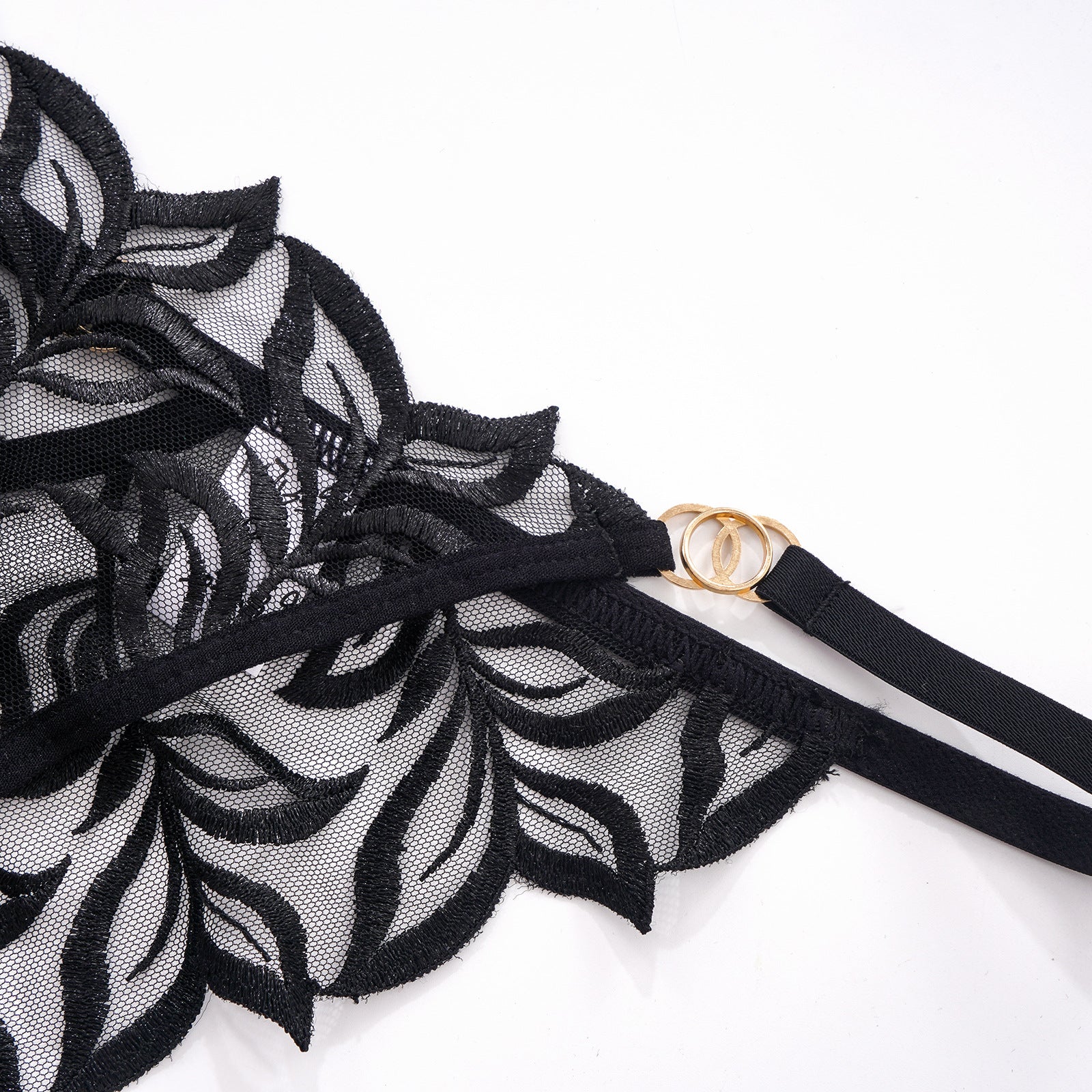 Close-up of the fixed side straps and polished metal ring accents on the hip.