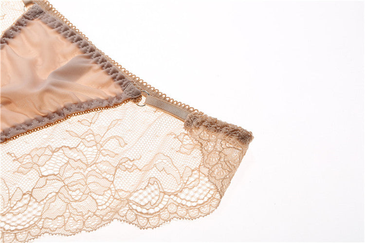 Detailed shot of the intricate floral eyelet lace and keyhole front on the satin panel.