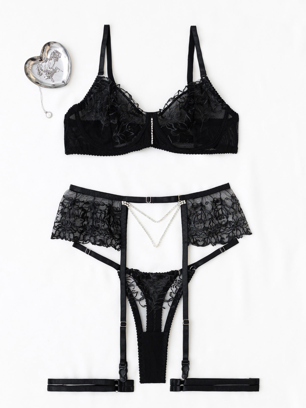 Front-view studio flat lay of the black 3-piece set on a white background, showcasing the "ink-effect" lace and architectural garter.
