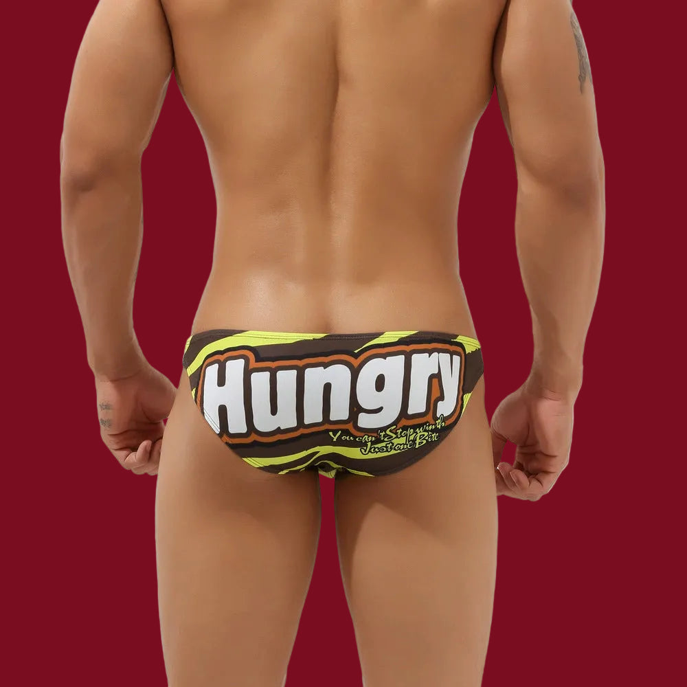 Rear view of the Hungry Heat brief featuring high-contrast comic-style HUNGRY lettering on a silky stretch-fit base.