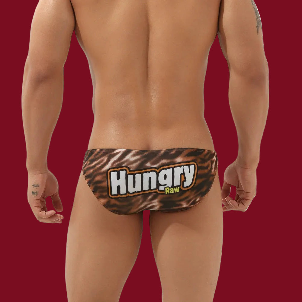 Rear view of the Hungry Raw Men's Brief on a signature burgundy background, highlighting the bold "Hungry Raw" graphic.