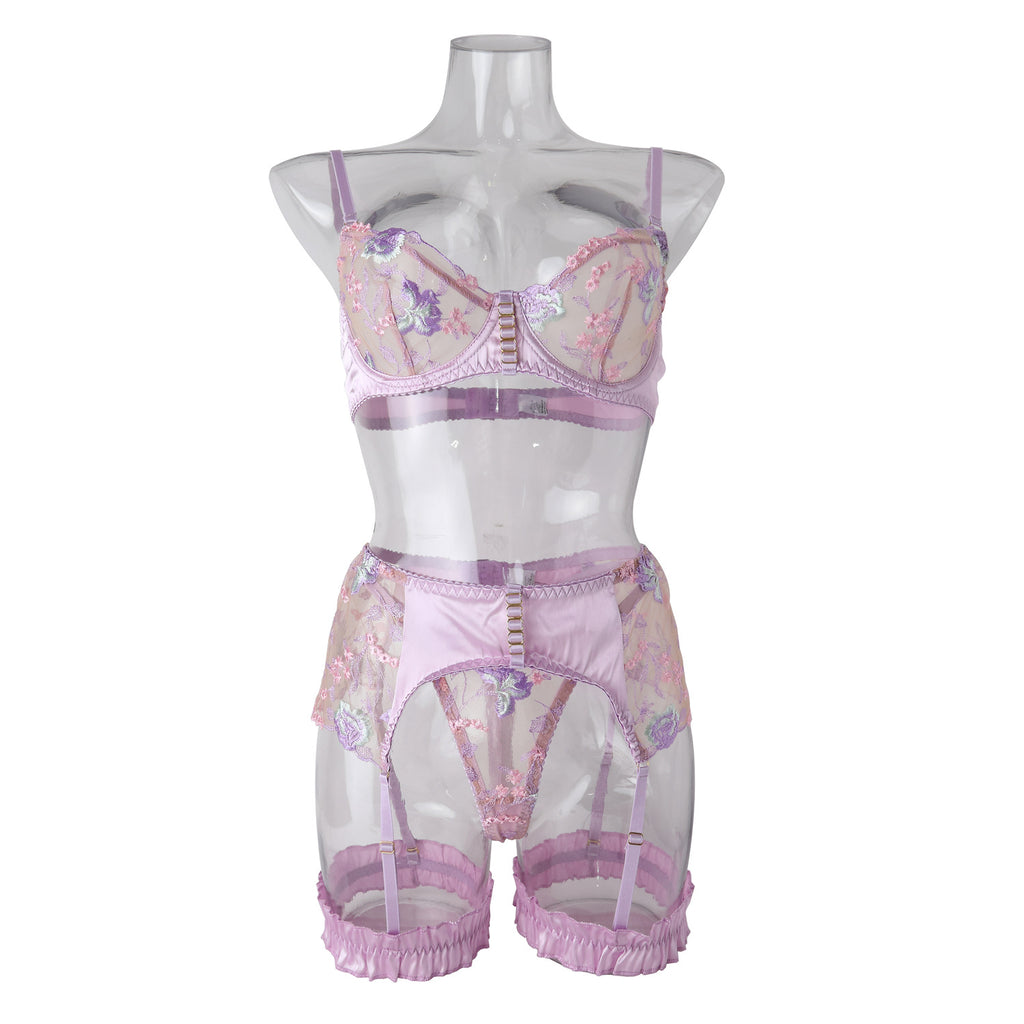 Lilac Sanctuary: A studio inventory view on a clear mannequin, providing a visual map of the 3-piece floral embroidery set and matching leg garters.