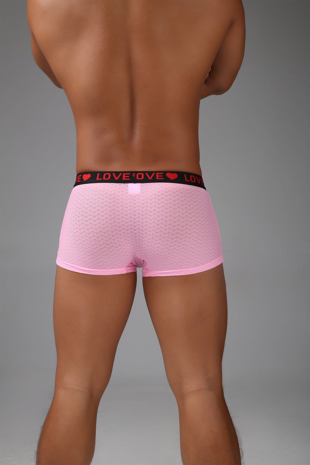Back view of men’s pink sheer mesh boxer with short-leg silhouette.