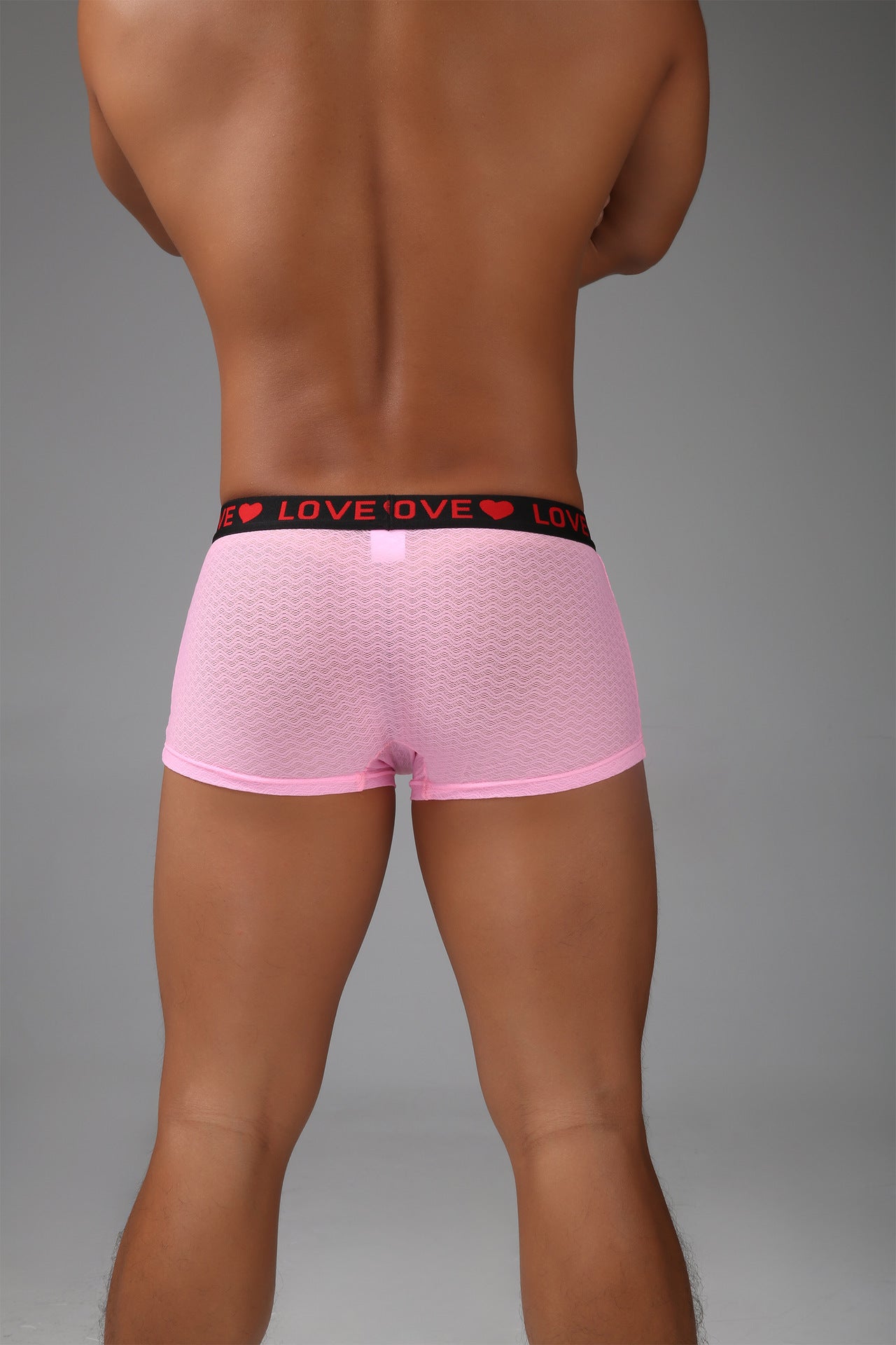 Back view of men’s pink sheer mesh boxer with short-leg silhouette.
