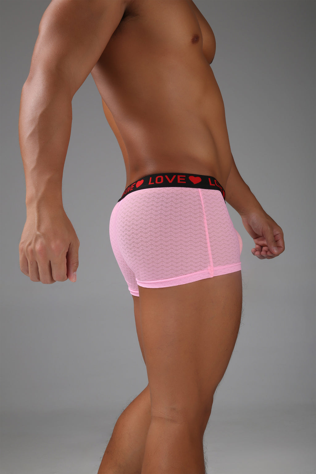 Sheer pink men’s boxer showing a clean side profile and smooth mesh texture.