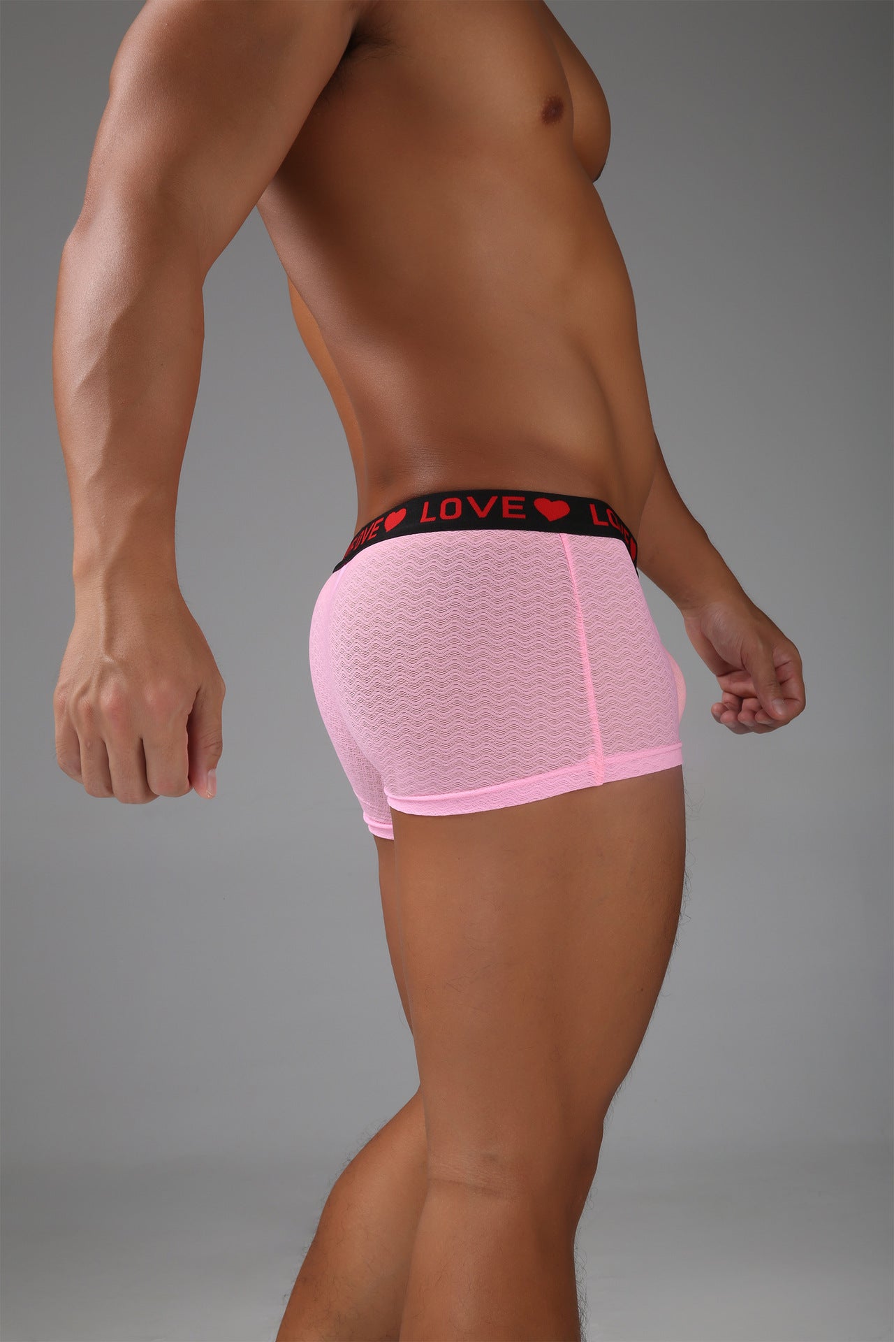Sheer pink men’s boxer showing a clean side profile and smooth mesh texture.