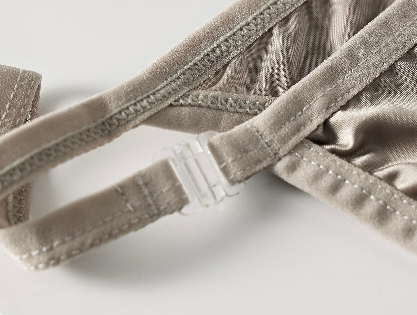 Close-up detail of adjustable side straps on The Lucent Precision Satin Thong highlighting refined construction.