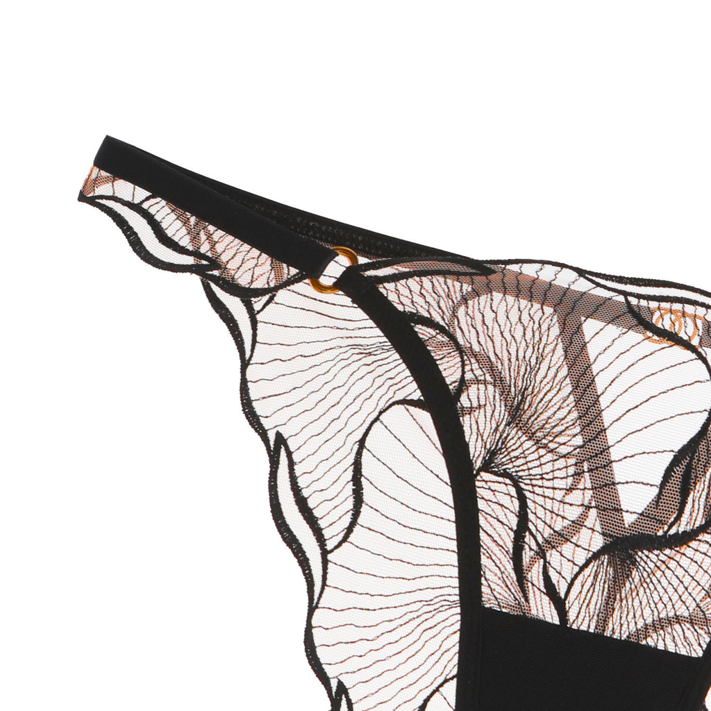 Close-up of the decorative gold-toned hip rings on the Velour Tide wave-inspired embroidered brief.