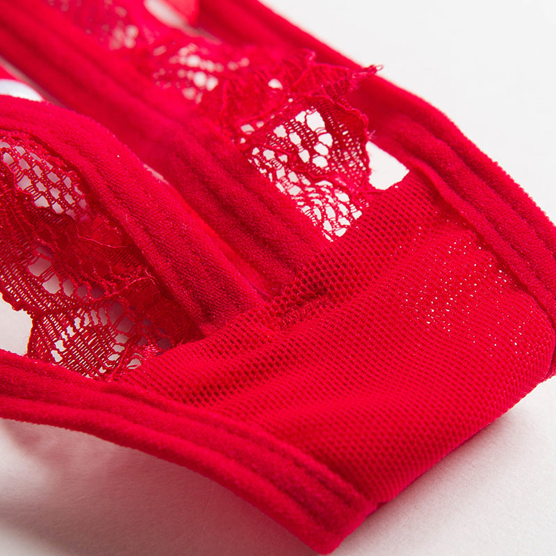 Close-up of the architectural red lace ruffles and breathable mesh fabric on the Lyra thong