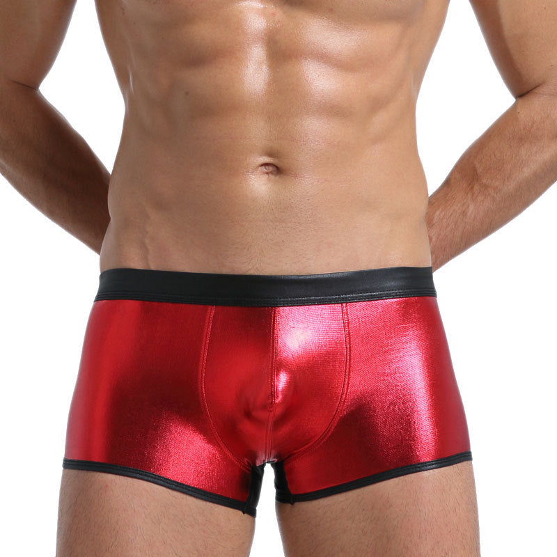 A provocative Magma Red metallic finish on a sculpted boxer brief, emphasizing muscle movement through light-bending fabric.