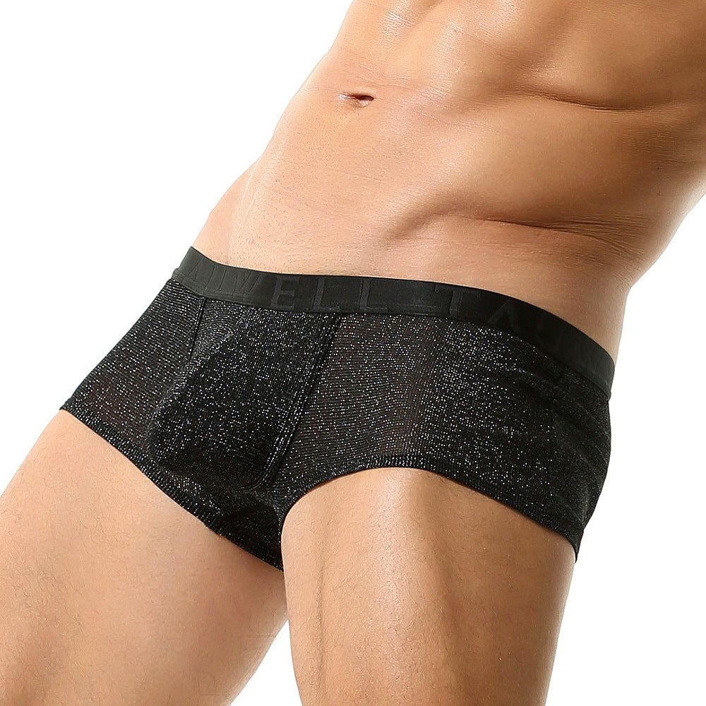 A low-angle, 45-degree profile shot. The camera angle emphasizes the lift of the sculpted pouch and the clean line of the matte black waistband against the skin.