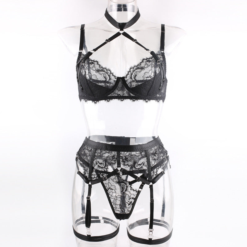 Front view on a transparent mannequin, illustrating the "floating" lace effect and the precise finish of the harness straps.