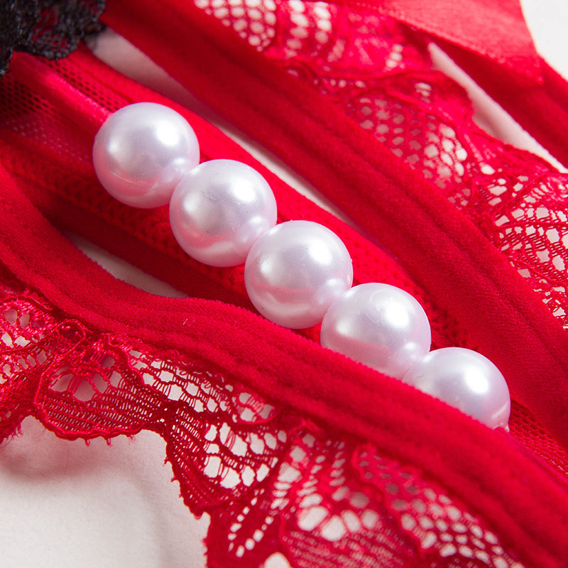 Technical close-up of the integrated high-luster pearl strand on the luxury Lyra thong.