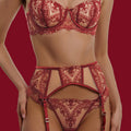 A focused front view of the Midnight Muse in red. This image showcases the scalloped edges of the balcony bra and the architectural straps of the garter belt against the sheer mesh.