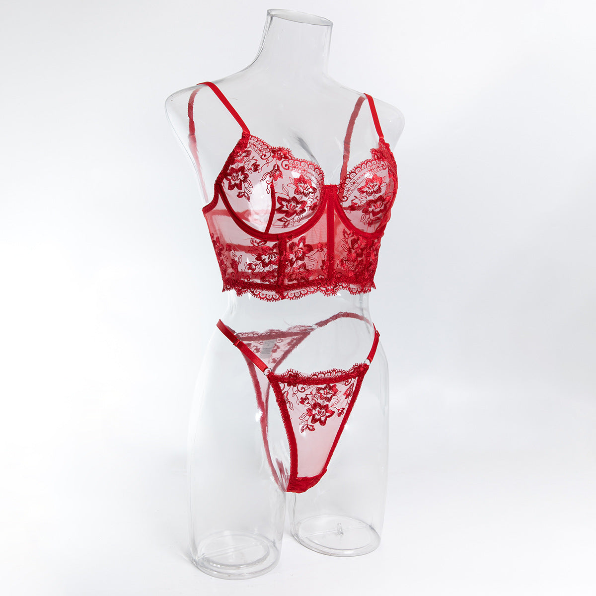 Angled mannequin view of the red floral set, emphasizing the premium finish and the luminous power of the design.