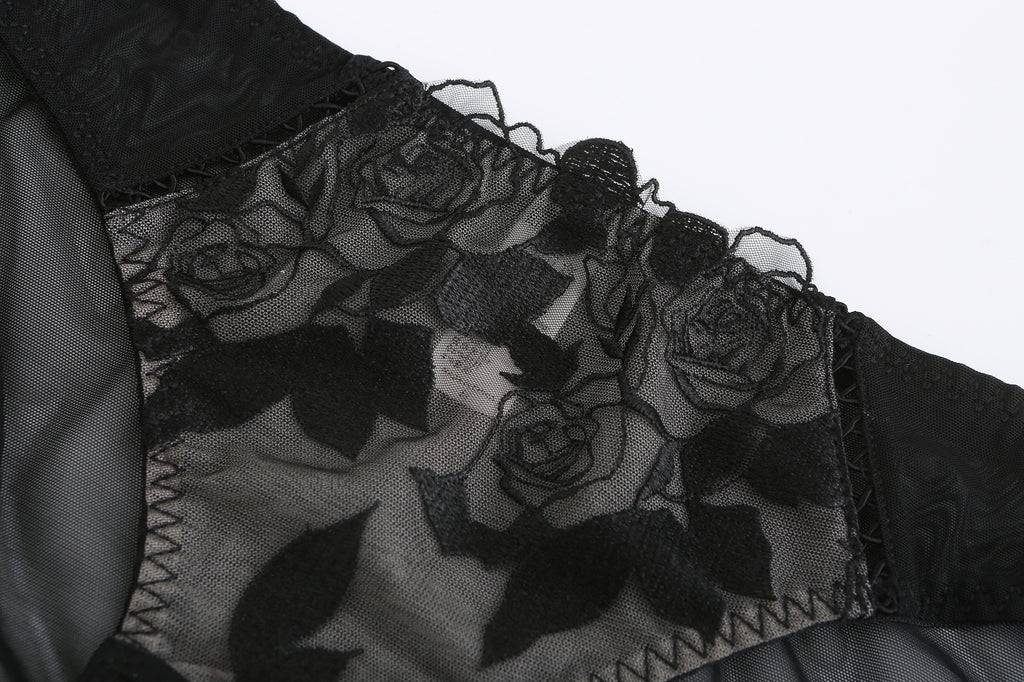 Detailed close-up of the black-on-black floral rose embroidery.