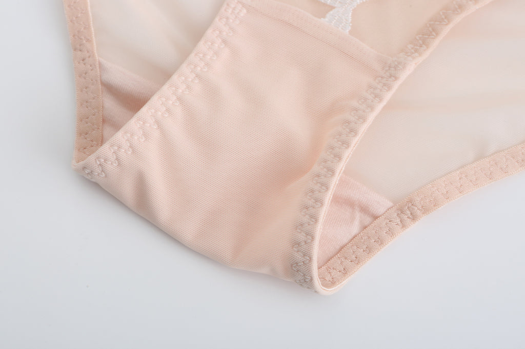 Flat lay exterior view of the nude Rosaine Rose embroidered lingerie.