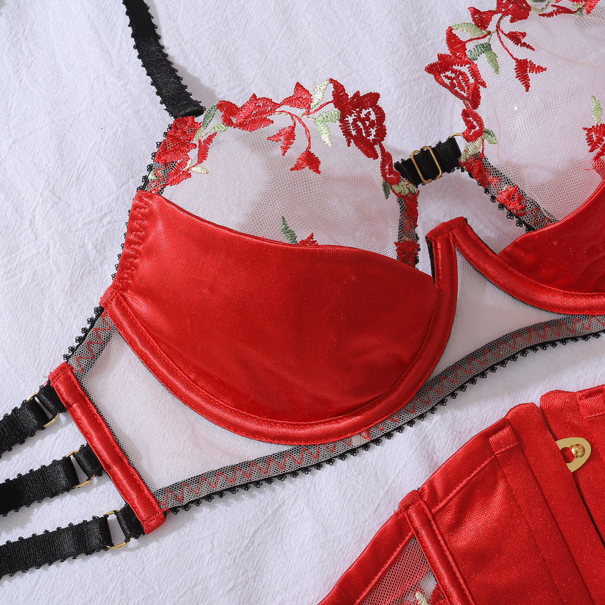 Detailed flat lay of the Rouge Dynasty bra, featuring the bloom of red florals and structured black framing for architectural support.