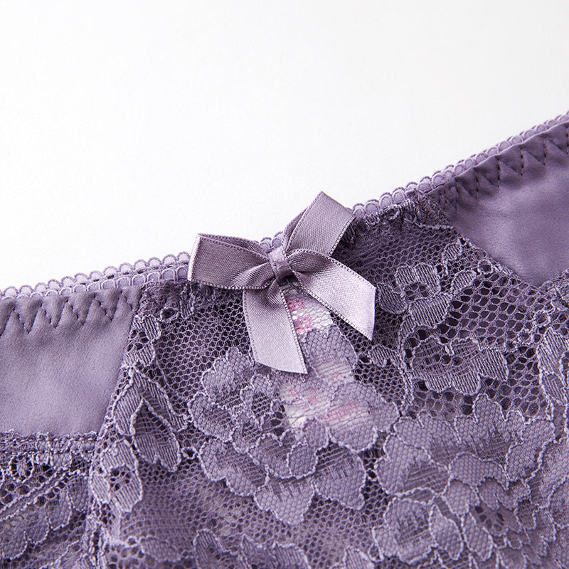 Close-up of the high-sheen satin waistband and floral lace transition.