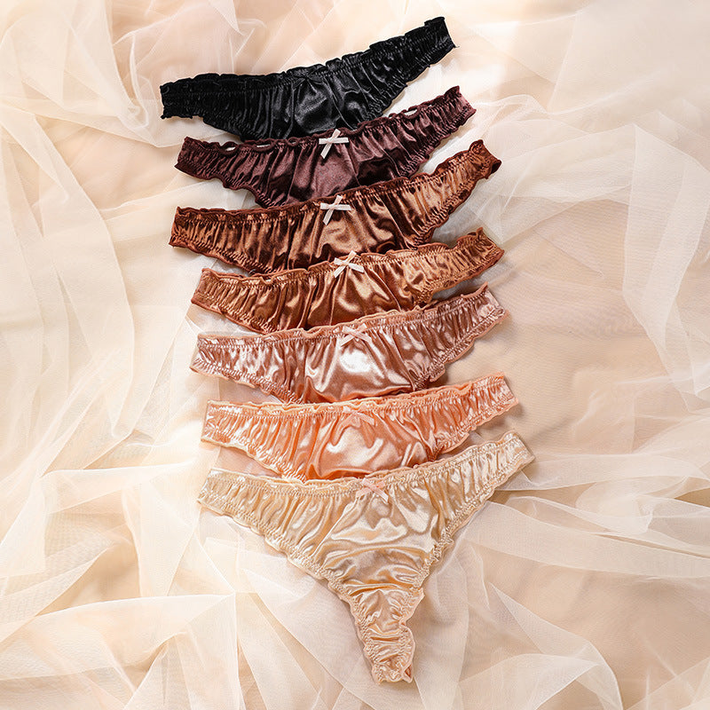Selection of satin thong panties displayed in neutral and warm color tones.