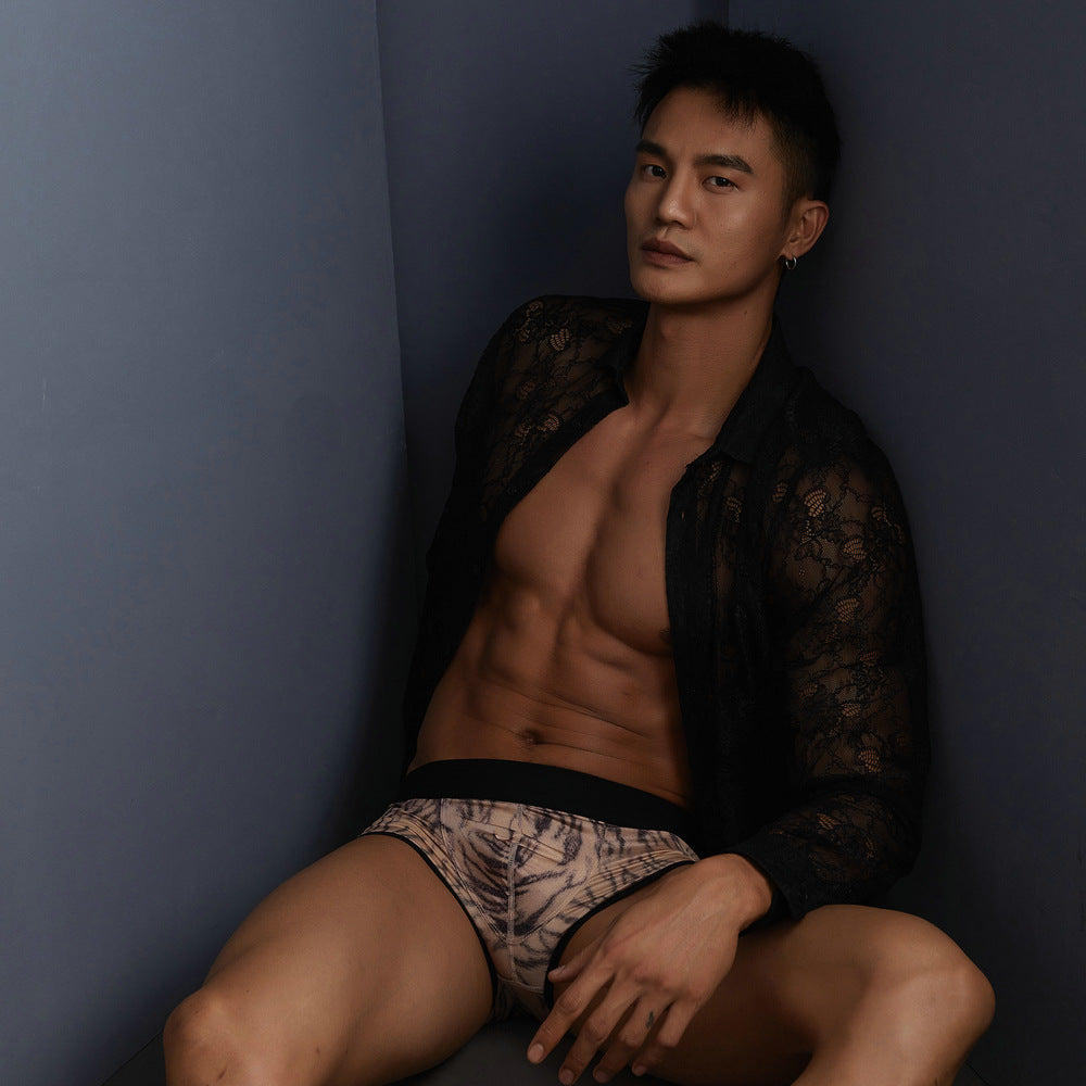 A seated, mood shot showcasing how the fabric and print interact with shadow for a subtle, sensual edge.