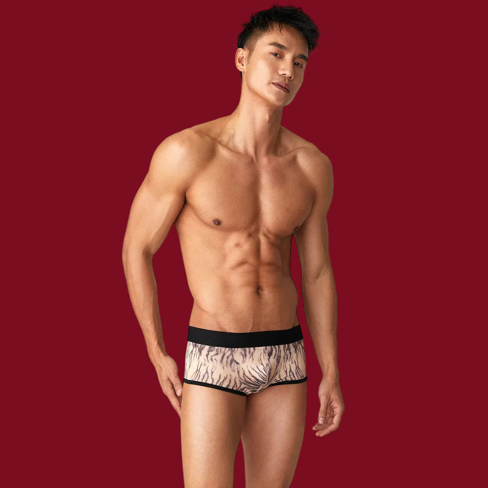 A clear front view of the Savannah Whisper Boxer Brief against a signature burgundy background, showcasing the refined tiger print and natural contour.