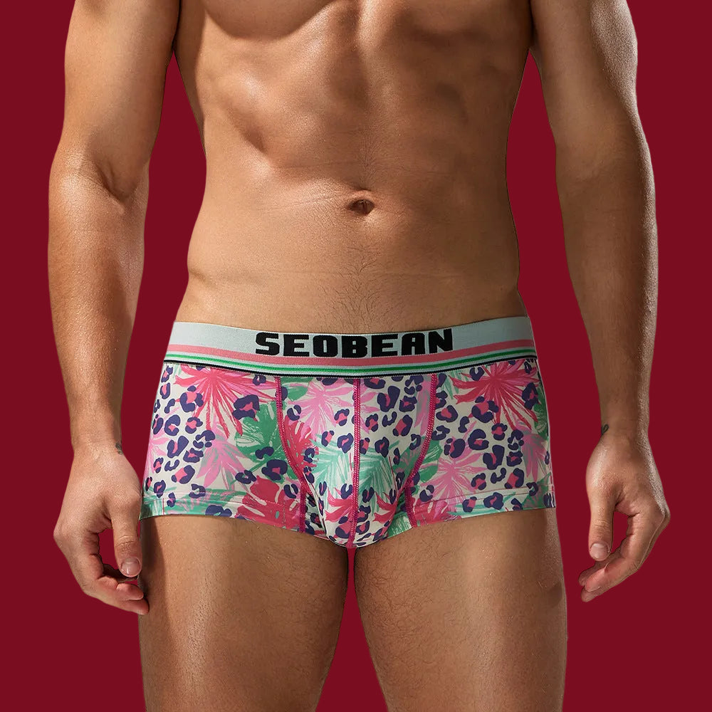 Front view of the SEOBEAN Wild Tropics boxer, set against a signature mooods burgundy background to highlight the vibrant watercolor print.