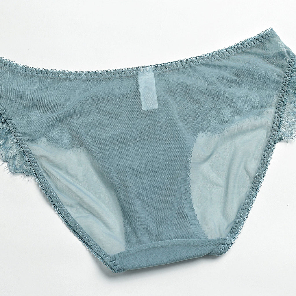 Rear view of floral lace texture and sheer mesh construction showing stretch and fine craftsmanship. 