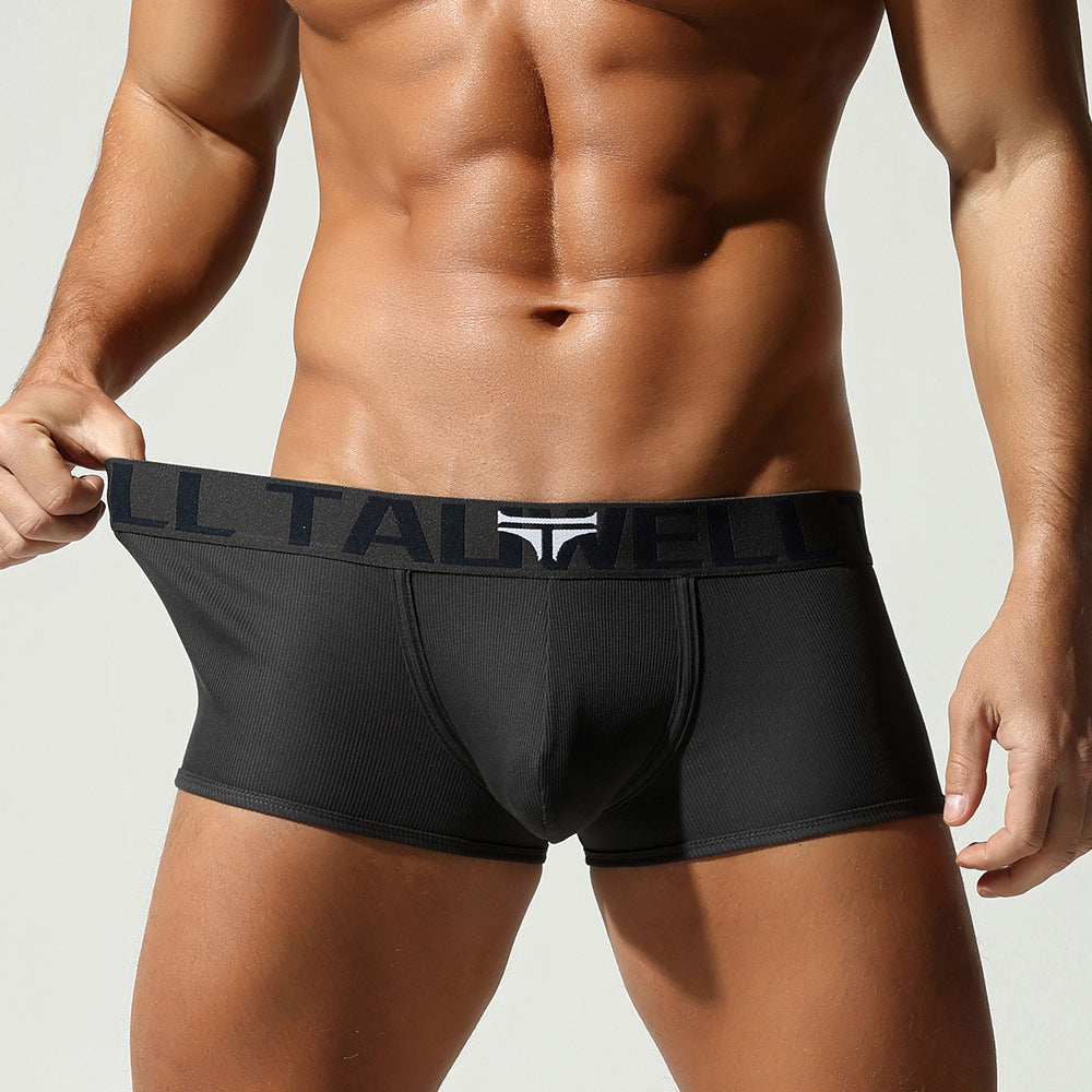 A front view of the Industrial Gray trunk with the waistband pulled, demonstrating the secure elastic hold and athletic frame.