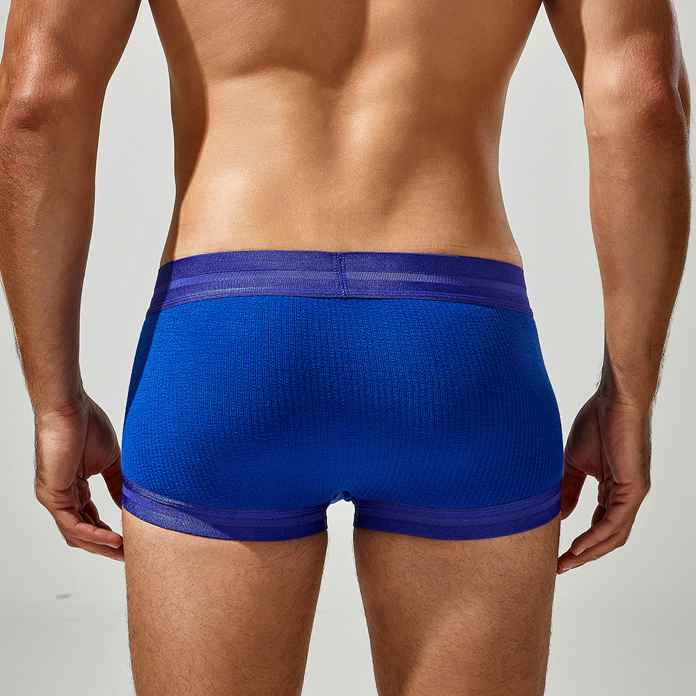 Rear view of the Tauwell indigo boxer demonstrating full-frame body contouring and comfort.