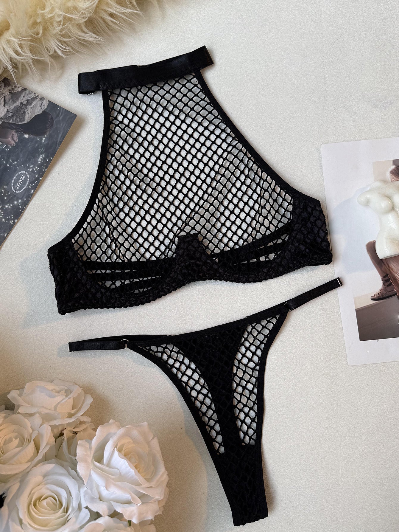 Aesthetic flat lay of the Obsidian Net set, illustrating the soft satin elastic and architectural fishnet frame for mooods.