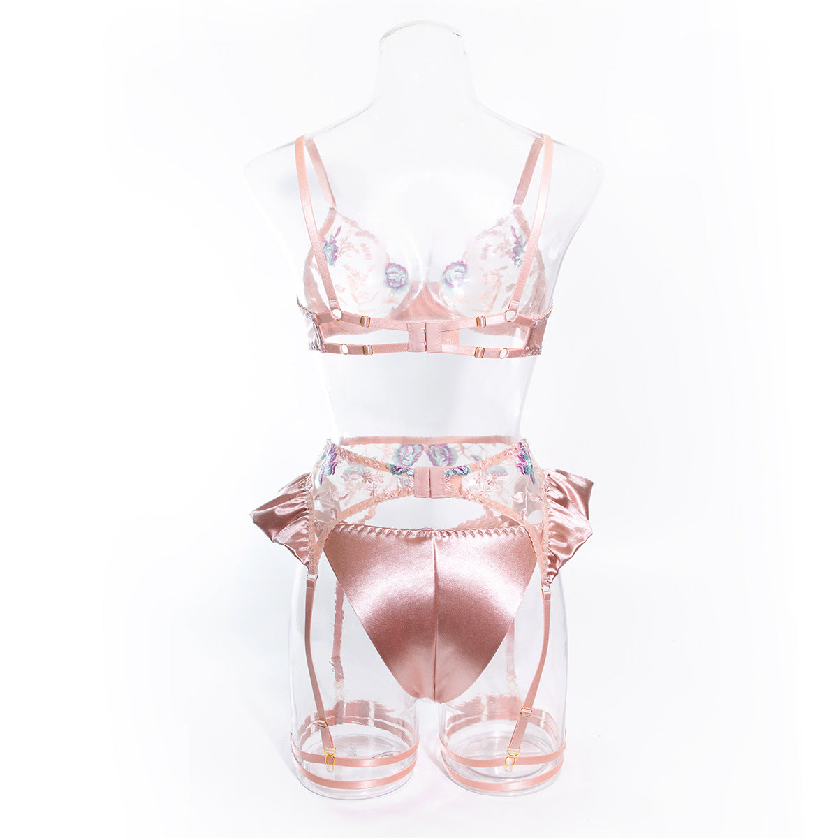 The back view of the Blush Pink ensemble. Emphasizing the tonal hardware and the elegant, minimal coverage of the embroidered honeymoon thong.