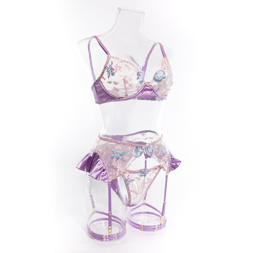 A side profile of the Lilac ensemble. This angle captures the volume of the satin ruffles on the garter belt and the precise fit of the embroidered cups.