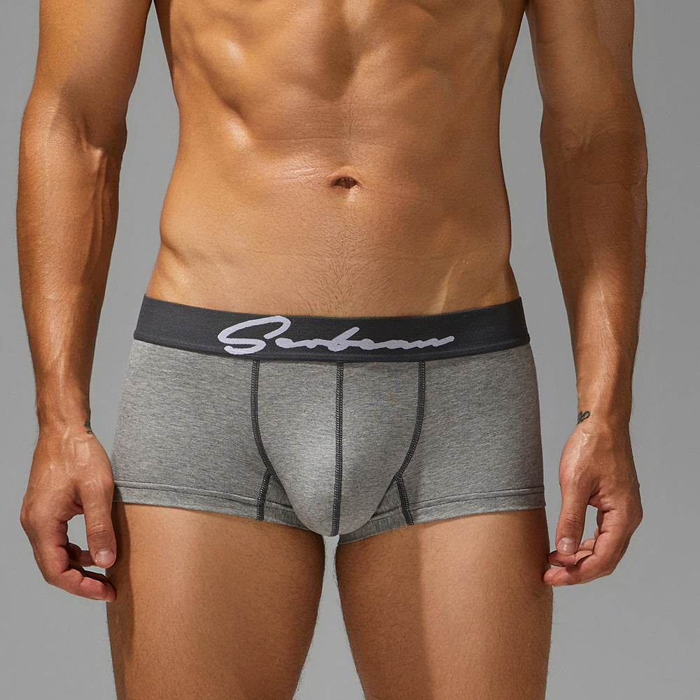 Male athlete in mineral grey cotton trunks; front view showing the soft-touch matte waistband.