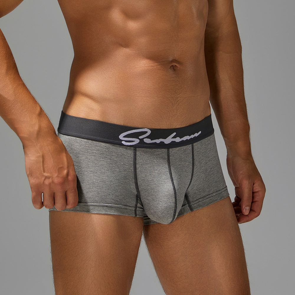 Side kinetic view of grey trunks on an athlete, highlighting the reinforced leg opening.
