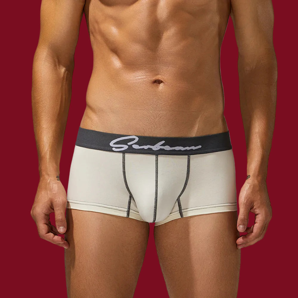 Frontal view of an athlete in pure chalk white cotton trunks; highlighting the crisp, clean architecture.