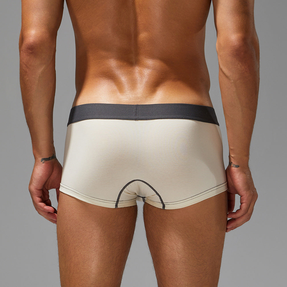 Rear silhouette of pure chalk white trunks on an athlete, focusing on the seamless, structured seat.