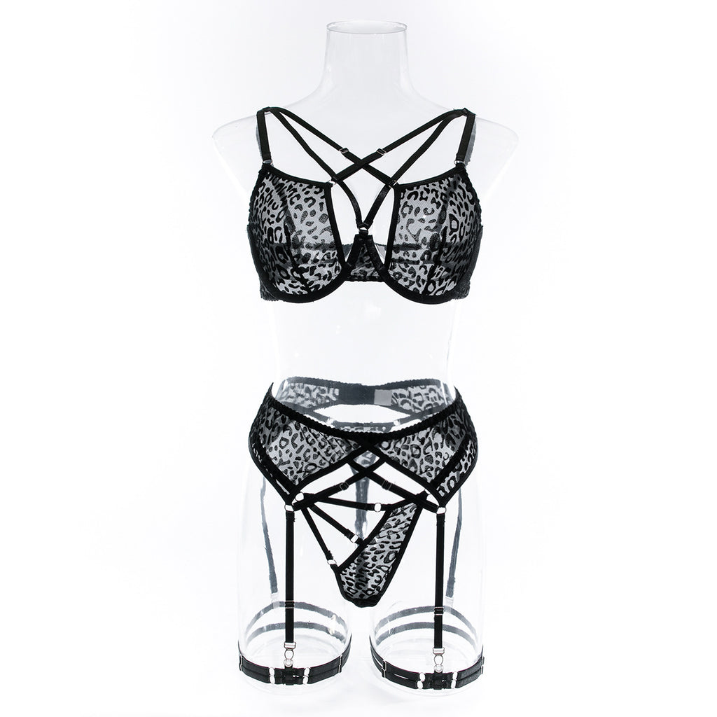 Front view of the strappy leopard set on a transparent mannequin, providing a clear look at the unlined bra structure and garter alignment.