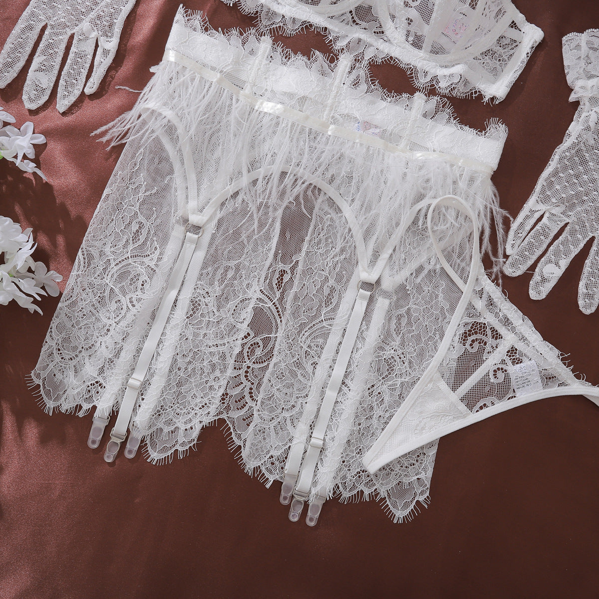 Detailed texture shot of the Weightless Hour garter belt, focusing on the airy white feathers and semi-sheer lace skirt.
