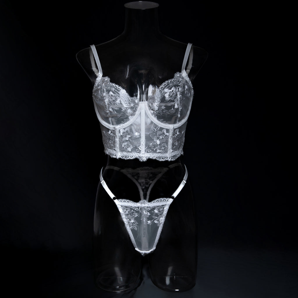 Front mannequin view of the white longline bra, highlighting the red-carpet lift and the artistry of the floral motifs.
